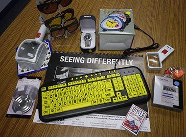Photo with sun blockers, large print playing cards, high contrast keyboard, liquid level indicators, magnifiers